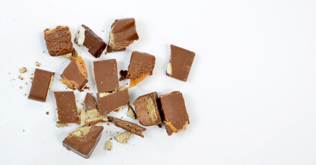 various sweet and tasty chocolate pieces isolated on white.top view