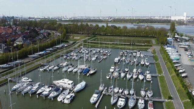 Drone aerial shot flying over Antwerp marina and boats
