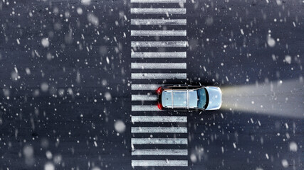 Aerial. Car driving at winter. Top view from drone.