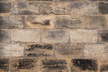 Massive stone wall made of sandstone blocks. Building exterior of an ancient house in Dresden. Grey...