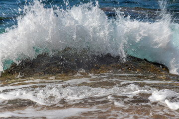 Splashing sea water on Corfu beach, Grecce.