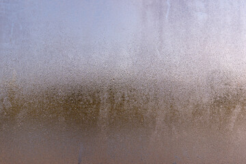Condensation water on a glass window. Water droplets in different size and shapes. Natural background texture when it is getting very cold outside. Abstract backdrop.
