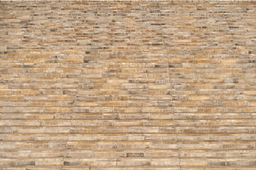 Stone stairs front view. Large staircase made of sandstone blocks. Building exterior detail as a background. Architecture elements out of natural material. Weathered stone bricks.
