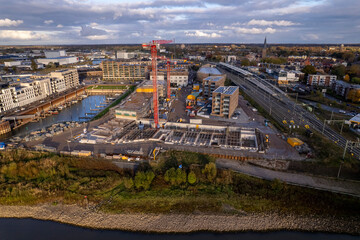 Construction site Kade Zuid part of the new Noorderhaven neighbourhood at riverbed of the  IJssel in Zutphen, The Netherlands. Aerial industrial view of building plot. Housing and urban management.