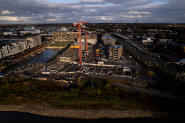 Kade Zuid construction site part of the new Noorderhaven neighbourhood at riverbed of the  IJssel in Zutphen, The Netherlands. Aerial industrial view of building plot. Housing and urban management.