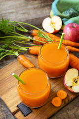 Fresh natural juice, healthy food concept. Glass jar of fresh apple and carrot juice on a wooden rustic table. Copy space.