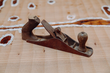 Old jointer plane laying on wood table