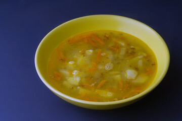 Vegan vegetable soup with potatoes, carrots and buckwheat.