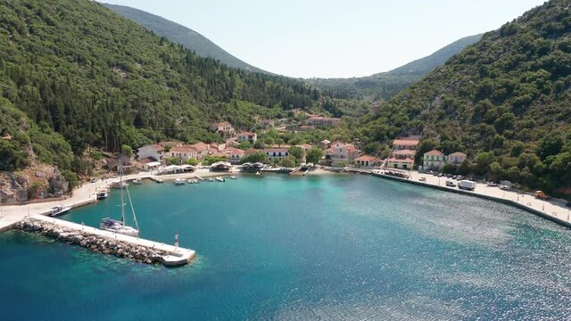 Drone view of Frikes port and moored bots on turquoise sea in Ithaca island Greece