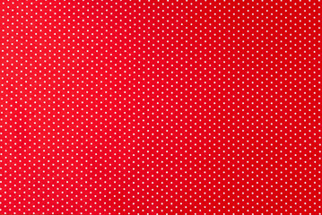 Obraz premium Background of red felt fabric with small white peas.