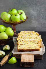 Apple and coconut loaf cake on wooden cutting board