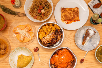 Set of Mediterranean food dishes with roast chicken, minced meat lasagna, stuffed peppers, potato omelette, carrot cake, croquettes and meatloaf