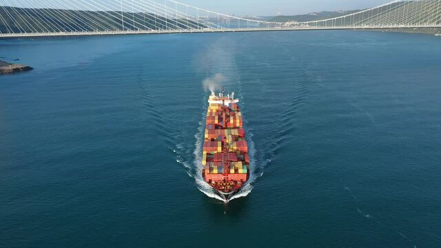 Container ship underway Bosphorus Bound leaving black exhaust fumes. Marine air pollution from ships degrades air quality and affects human health also contributes to climate change. Exhaust emissions