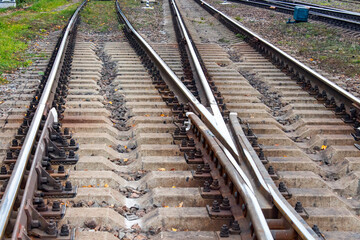 A railway with rails and concrete sleepers.Background of an old rusty railway.Rails and sleepers on the railway.