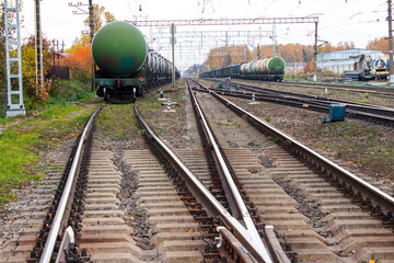 A railway with rails and concrete sleepers.Background of an old rusty railway.A railway with interchanges of tracks.