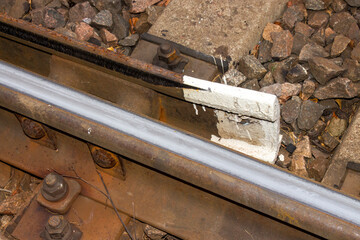 A railway with rails and concrete sleepers.Background of an old rusty railway.A railway with interchanges of tracks.
