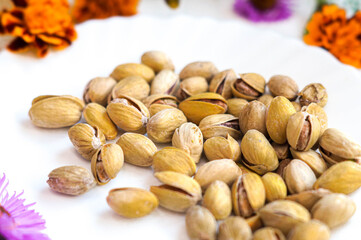 Salted pistachios on a white plate