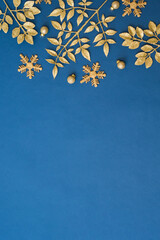 Christmas holiday composition. Flat lay frame with christmas golden decorations on a blue background