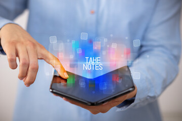 Young man holding a foldable smartphone