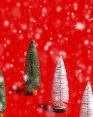 Pattern with Christmas tree white and green colored on red background with snow. Minimal New Year layout with festive fir, xmas decoration backdrop, winter holiday concept