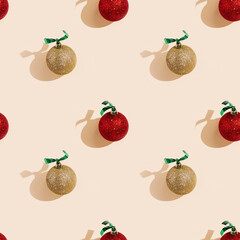 Happy holidays, Merry Christmas, New Year seamless pattern. Shiny red and golden Christmas balls or round baubles with shadows on pastel pink