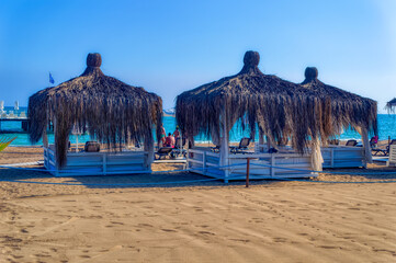 Beach bungalows during summer day.