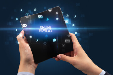 Businessman holding a foldable smartphone, social media concept