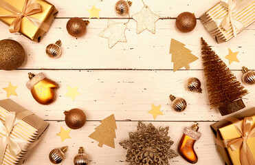  Christmas decorative composition with gold shiny snowflakes, christmas golden balls, gift boxes on rustic white wood background. Vintage Christmas or New Year concept. Festive Christmas background/