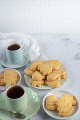 Setting of Christmas Shortbread and Tea on Marble Table Vertical with Copy Space