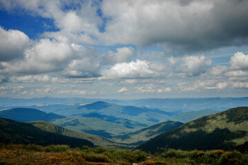 Obraz na płótnie Canvas Incredibly beautiful panoramic views of the Carpathian Mountains. Peaks in the Carpathians on a background of blue sky