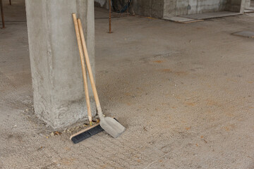 Shovel and broom for construction site cleaning. Tool for cleaning construction waste. Cleanliness at the construction site. Cleaning of construction waste