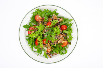 Plate with vegetarian dish of arugula, tomatoes and mushrooms on white background. Studio Photo