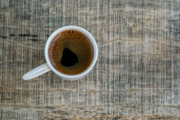 cup of coffee on the wooden table with copy space