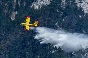 An italien Canadair plane drops water during a forest fire in Hirschwang, Austria