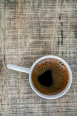 cup of coffee on the wooden table with copy space