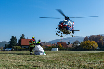 Firefighters supporting a Police Helicopter to transport equipment to a mountain forest fire in Hirschwang, Lower Austria