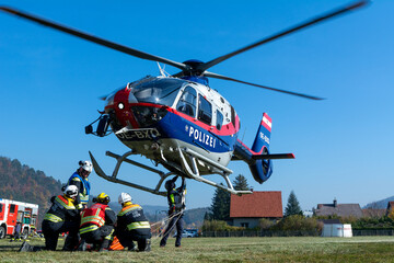 Firefighters supporting a Police Helicopter to transport equipment to a mountain forest fire in Hirschwang, Lower Austria