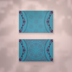 Business card in turquoise color with Indian purple ornaments for your contacts.