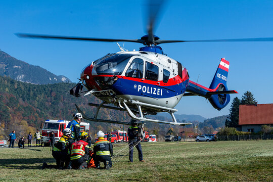 Firefighters supporting a Police Helicopter to transport equipment to a mountain forest fire in Hirschwang, Lower Austria