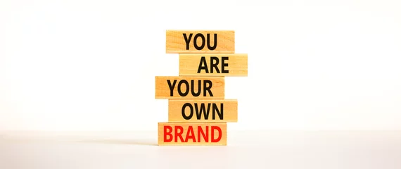 Fotobehang You are your own brand symbol. Wooden blocks with words You are your own brand. Beautiful white background, copy space. Business, you are your own brand concept. © Dzmitry