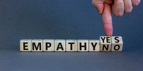 Empathy yes or no symbol. Psychologist turns wooden cubes and changes words empathy no to empathy...