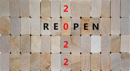 2022 reopen new year symbol. Wooden blocks with words 'Reopen 2022'. Beautiful wooden background, copy space. Business, 2022 reopen new year concept.