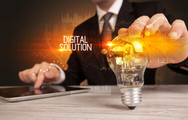 Businessman holding a lightbulb concept
