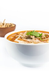 Close up of chicken tortilla soup . Mexican soup on white background