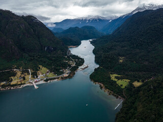 Aerial view of lake tagua tagua with snow-capped mountains in the background.