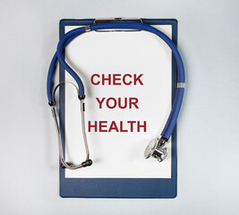 Check your health phrase. Words on paper with stethoscope.