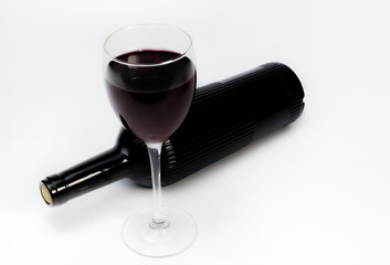 a glass of red wine and a bottle of wine