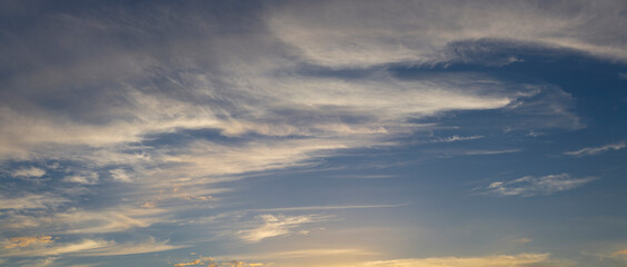 Cirrus cloudscape on blue sky. The evening sunset. Majestic Clouds.