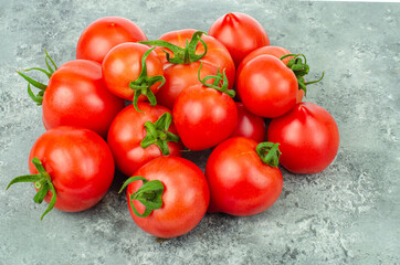 Bunch of ripe tomatoes on blue-gray background. Studio Photo