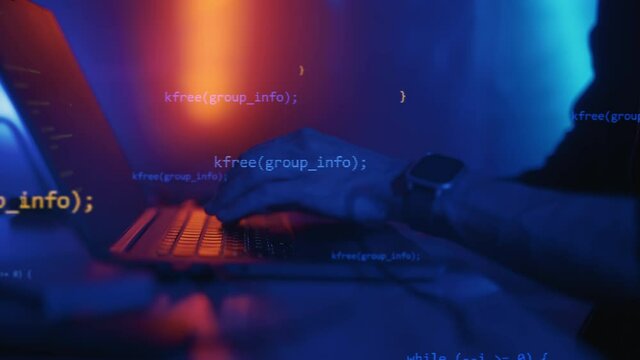 Hacker is working on laptop at night. Hands are typing a virus code at keyboard or hacking website. Concept of bitcoin cryptocurrency and wallet hack. Software coder or blockchain developer